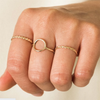 Hand with 14K Gold-Filled Thin Braid Ring, Flat Disc Band, and Karma ring.