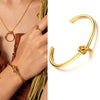 Woman in brown wearing gold plated Timeless Knot Cuff Bangle 