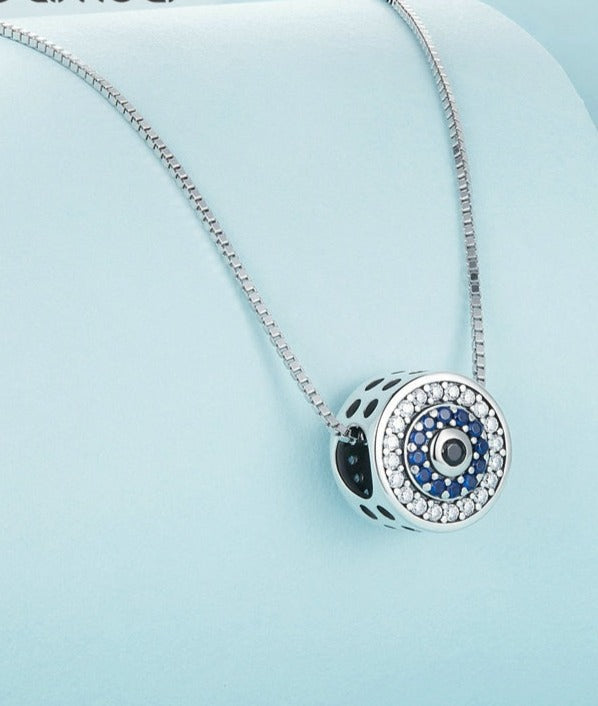 Close up of Evil Eye Necklace with zirconia, blue stone, and black stone in center. 