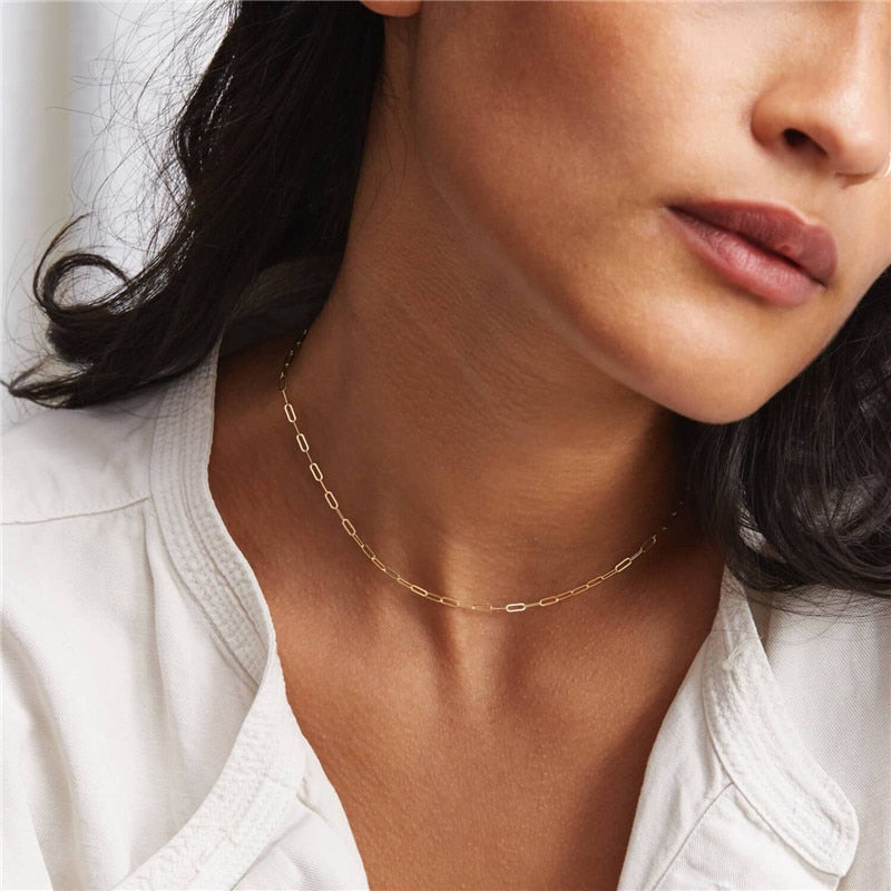Woman with dark hair and white shirt wearing 14K Gold-Filled Oval Link Chain as a choker. 