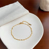 Beautiful 18K gold plated Heart Chain Anklet against white fabric.