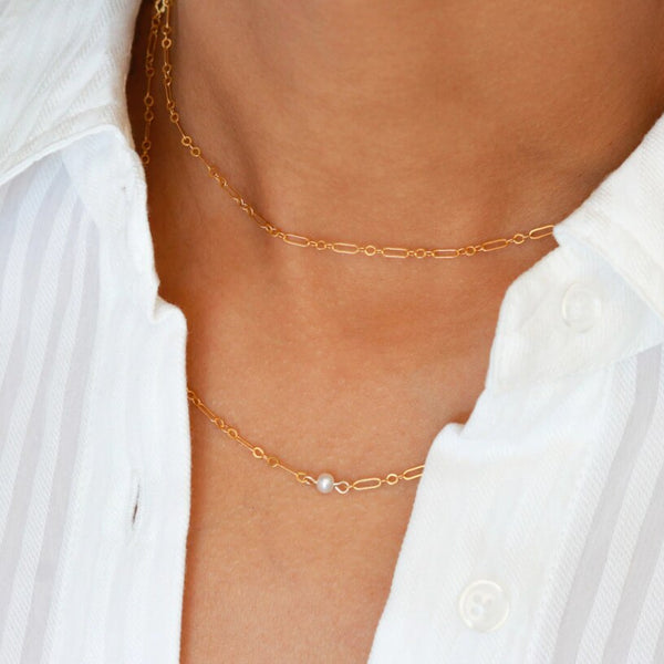 Gold Filled Thin Figaro Single Pearl Necklace  layered with a shorter gold filled figaro necklace. 