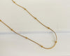 18K Gold plated Thick Beaded Chain laying on stone