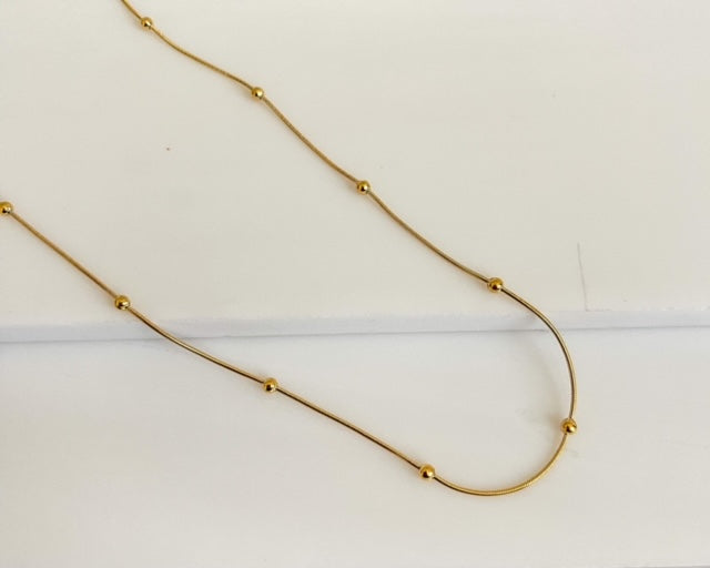 18K Gold plated Thick Beaded Chain laying on stone