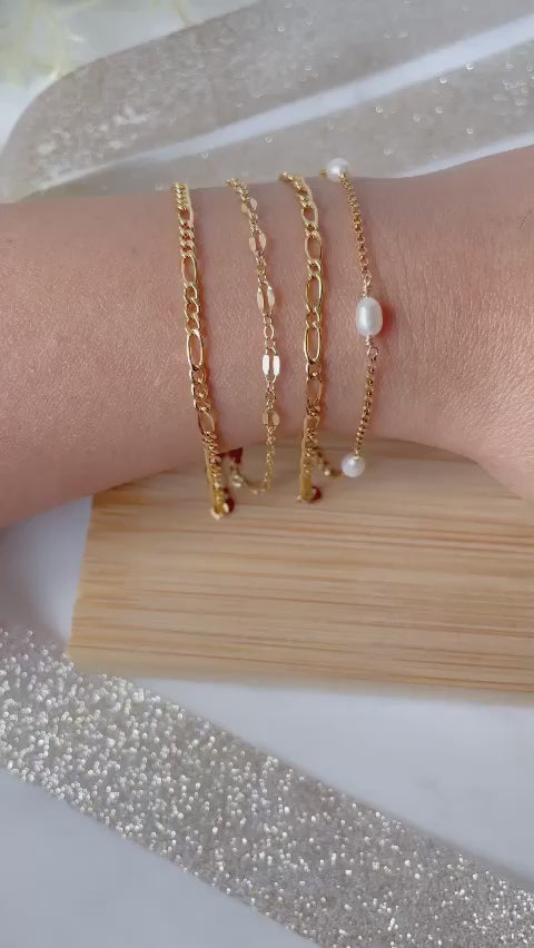 Four gold filled bracelets on hand moving up and down. 