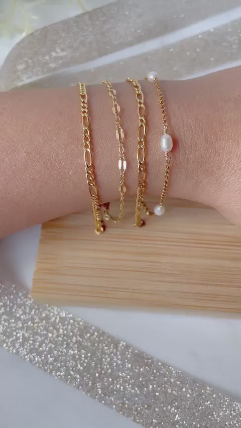 Multiple gold filled bracelets on hand moving left and right.