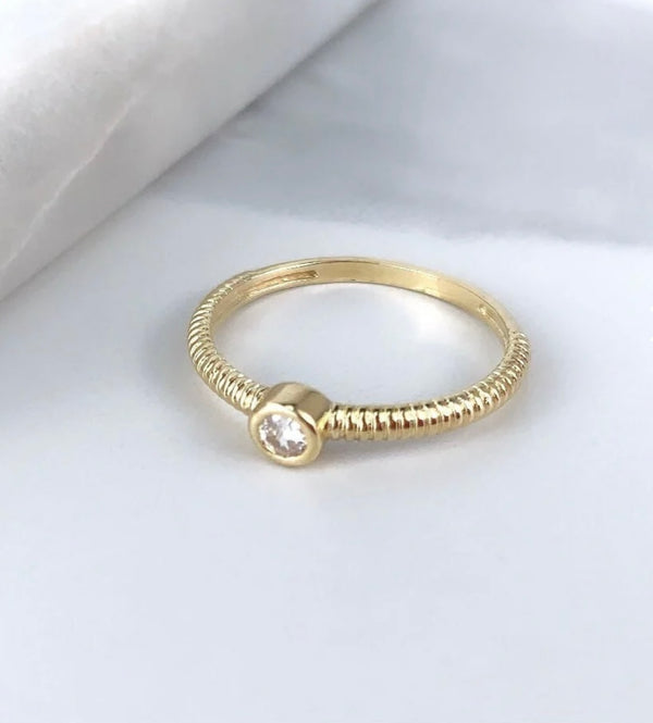 Detailed close up of 18K Gold Filled Spiral Diamond Bezel Ring on white background.
