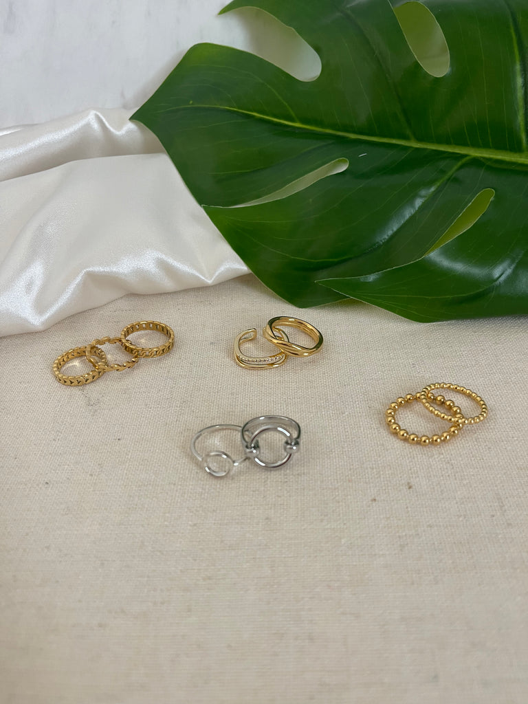 Collection of Rings offered by NAZ Parure including 18K Gold Plated Thin Chain Ring.