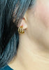 Woman with dark hair wearing Triple Hoop Earrings from NAZ Parure Jewelry